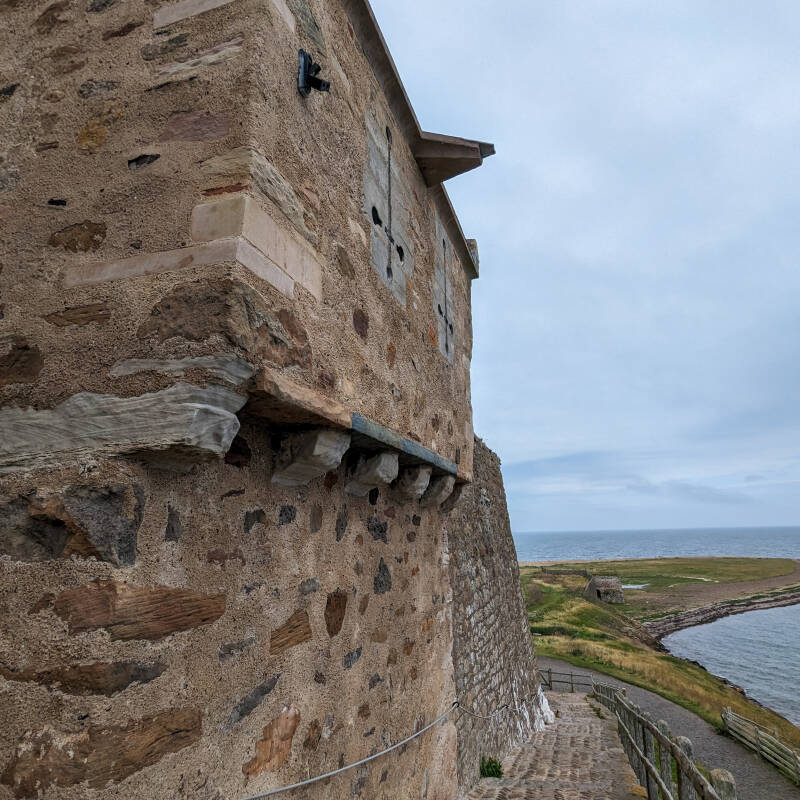 Steep cobbled steps leading up beside Lindisfarne Castle with the sea below