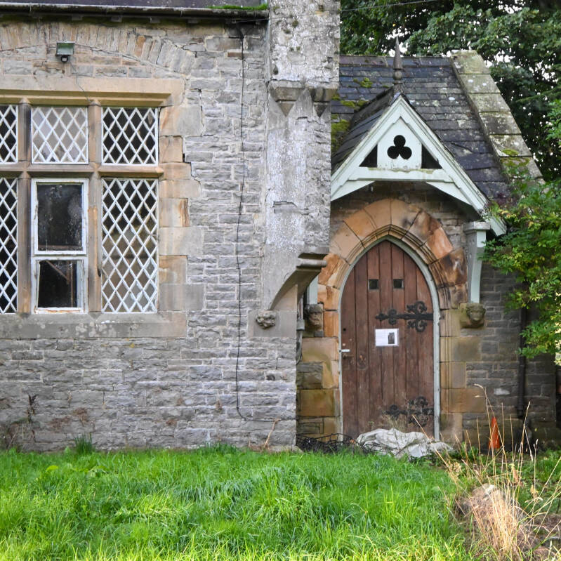 Pointed stone doorway and leaded windows of the former London Lead Company School on Alston Road