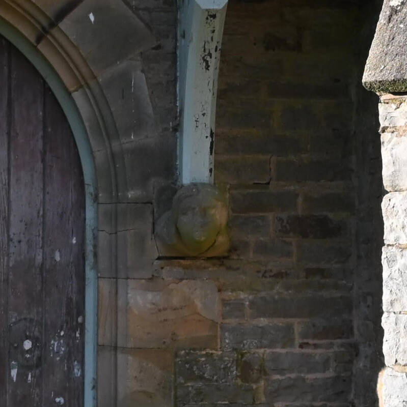 Close-up of a Victorian carved stone head beside the doorway of the 1861 London Lead Company School in Middleton-in-Teesdale