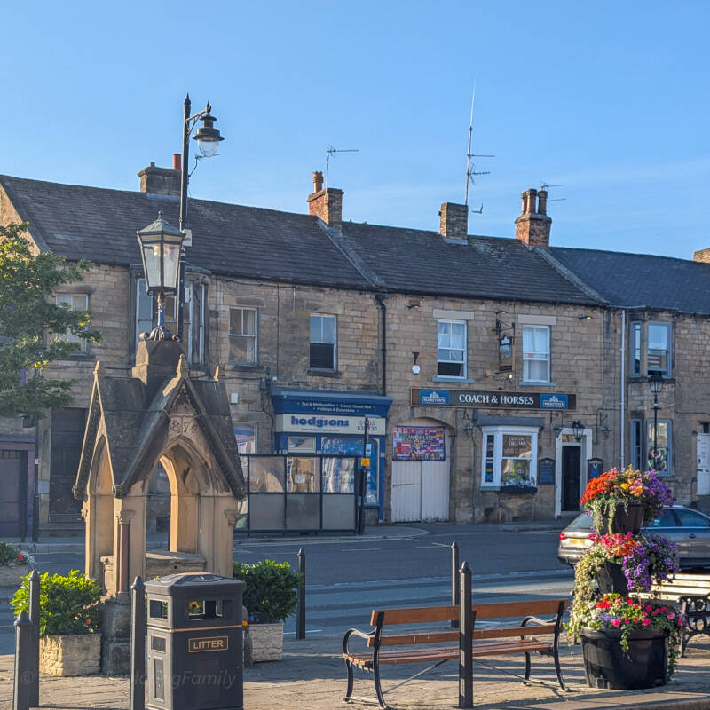 Lower Galgate in Barnard Castle, showing the Coach and Horses, stone buildings and the Market Place lamp.