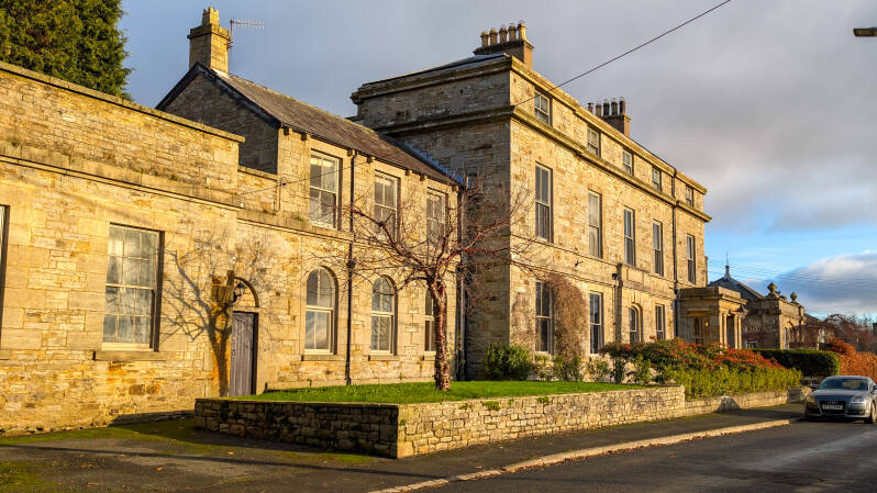 Full frontage of Middleton House on Hude in Middleton-in-Teesdale, showing the tall central house and lower wing