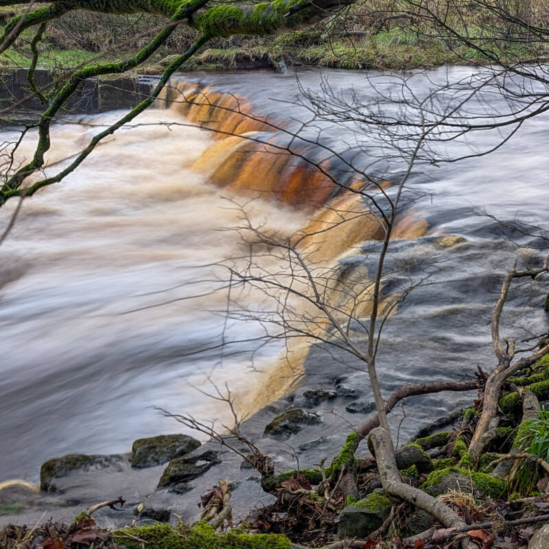 Mill Force waterfall and surviving mill remains beside the River Greta