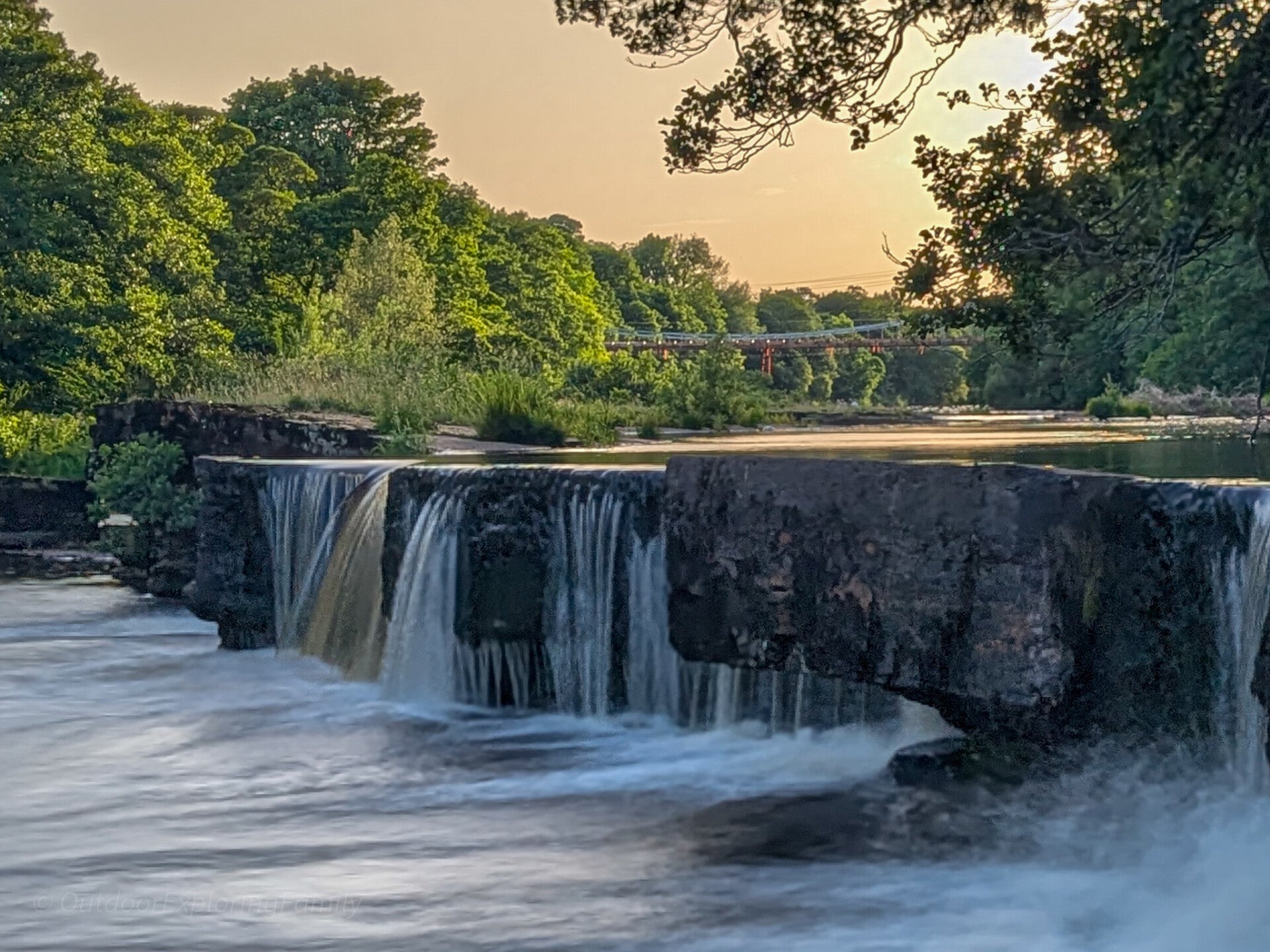 Water flowing over an old fish weir on the River Tees near Whorlton