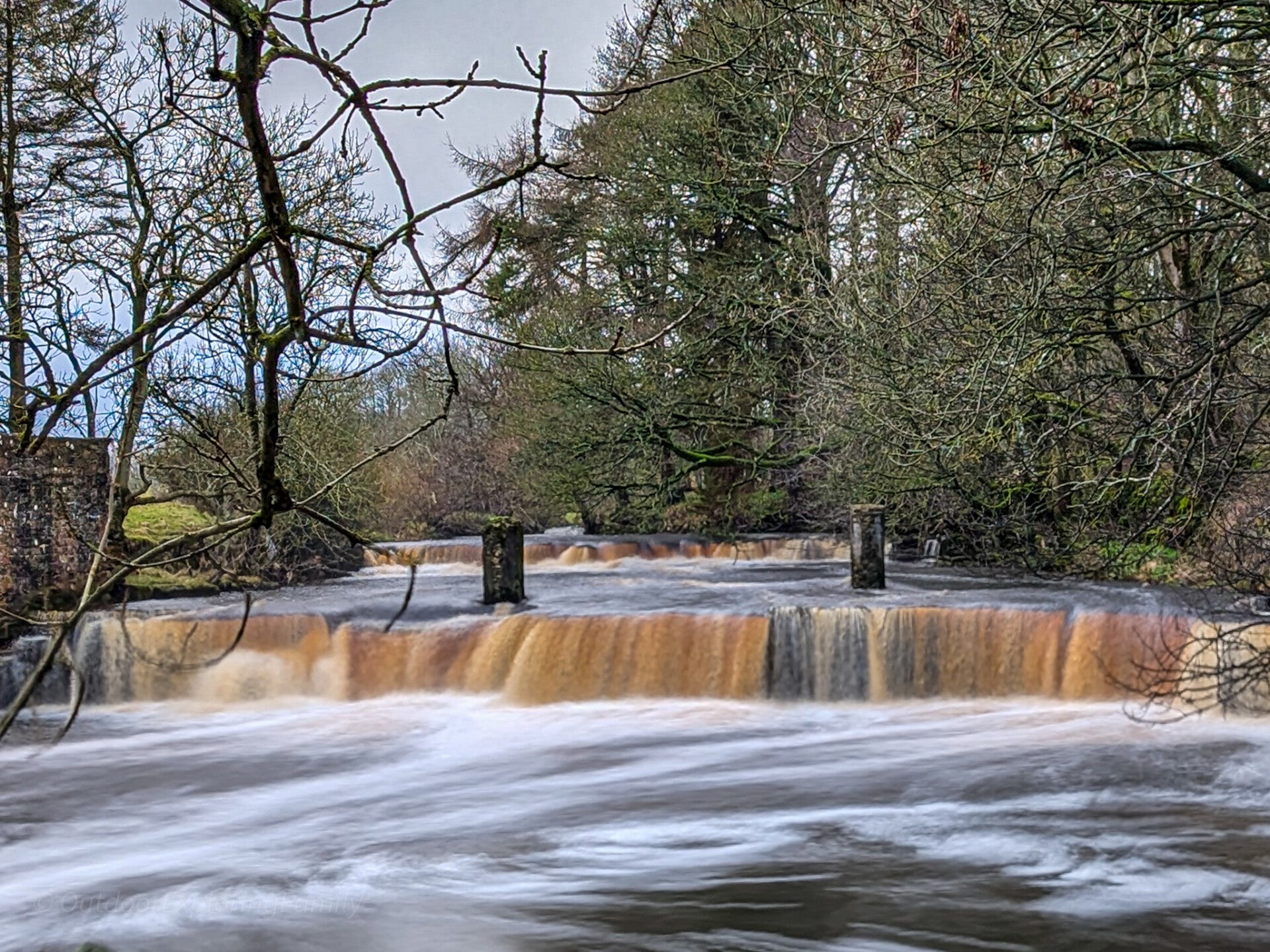 Mill Force waterfall on the River Greta near Bowes with the remains of the old mill weir