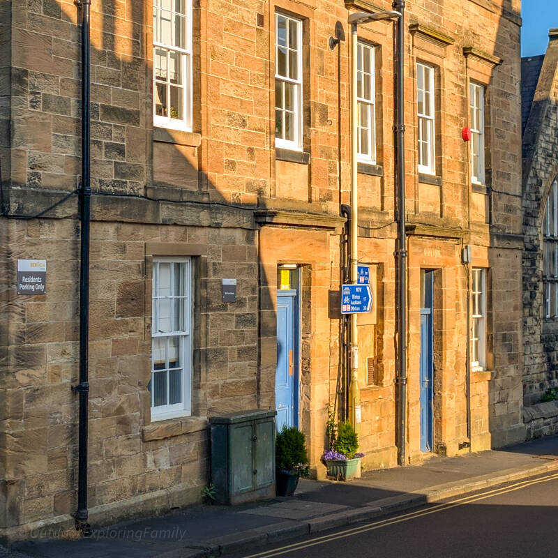Stone frontage, sash windows and blue doorway of the former Barnard Castle police station on Queen Street.