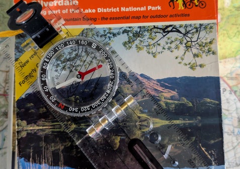 a picture of a os map and a compass