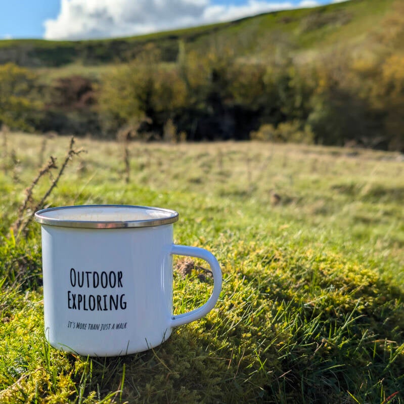Outdoor Exploring Family mug placed outdoors, symbolising adventure, calm and connection with nature.