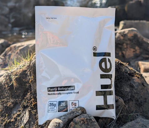 Huel Hot and Savoury pouch outdoor adventure meal replacement by a waterfall