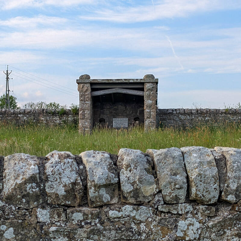 Victorian style mineral spring shelter at Red Well near Barnard Castle surrounded by historic stone walls and open countryside