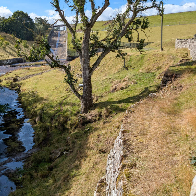 River Balder beside the former Hury Mill site with Hury Reservoir dam rising behind.