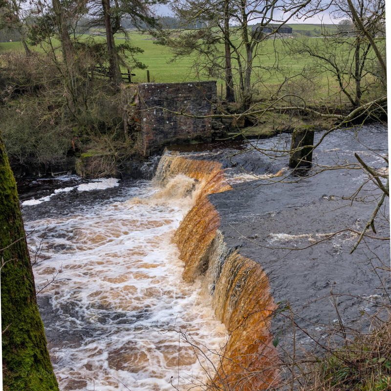Mill Force waterfall and surviving remains of the old mill beside the River Greta at Bowes