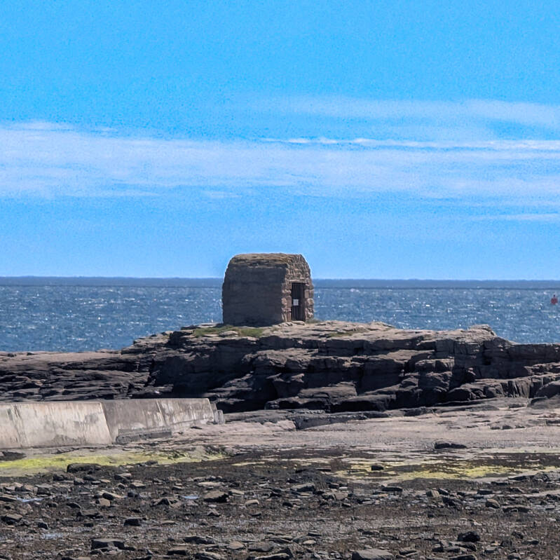 Historic stone Powder House standing on the rocks at Pace Hill, Seahouses