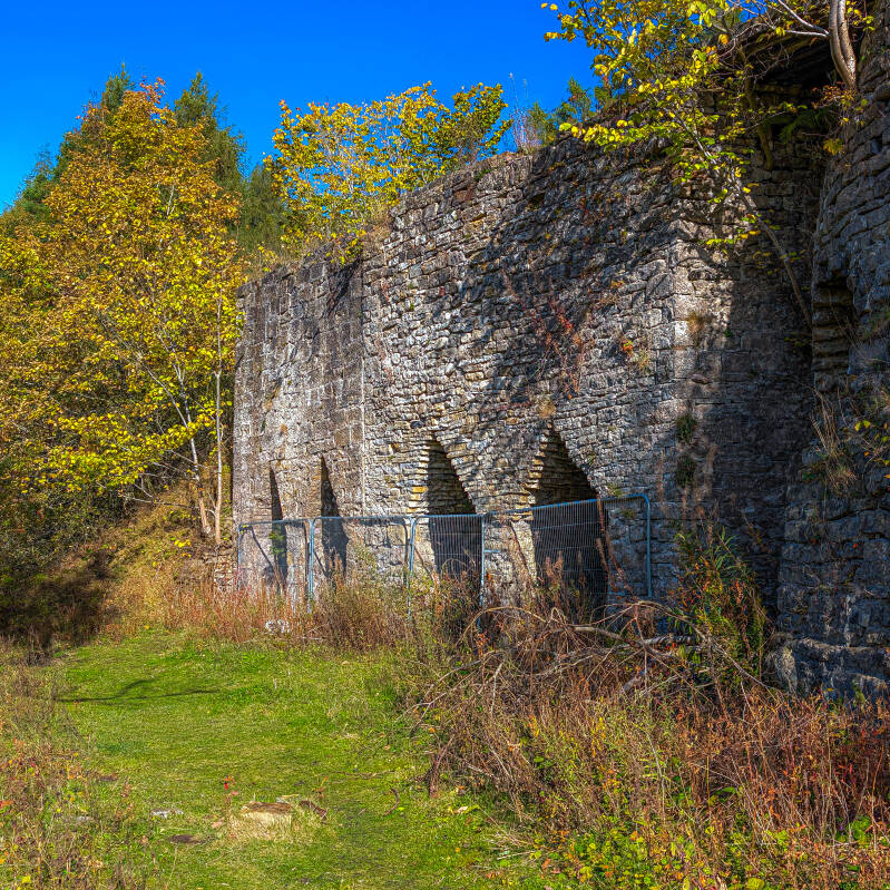Historic stone arches and towering walls of Skears Lime Kilns beside Hudeshope Beck near Middleton-in-Teesdale.