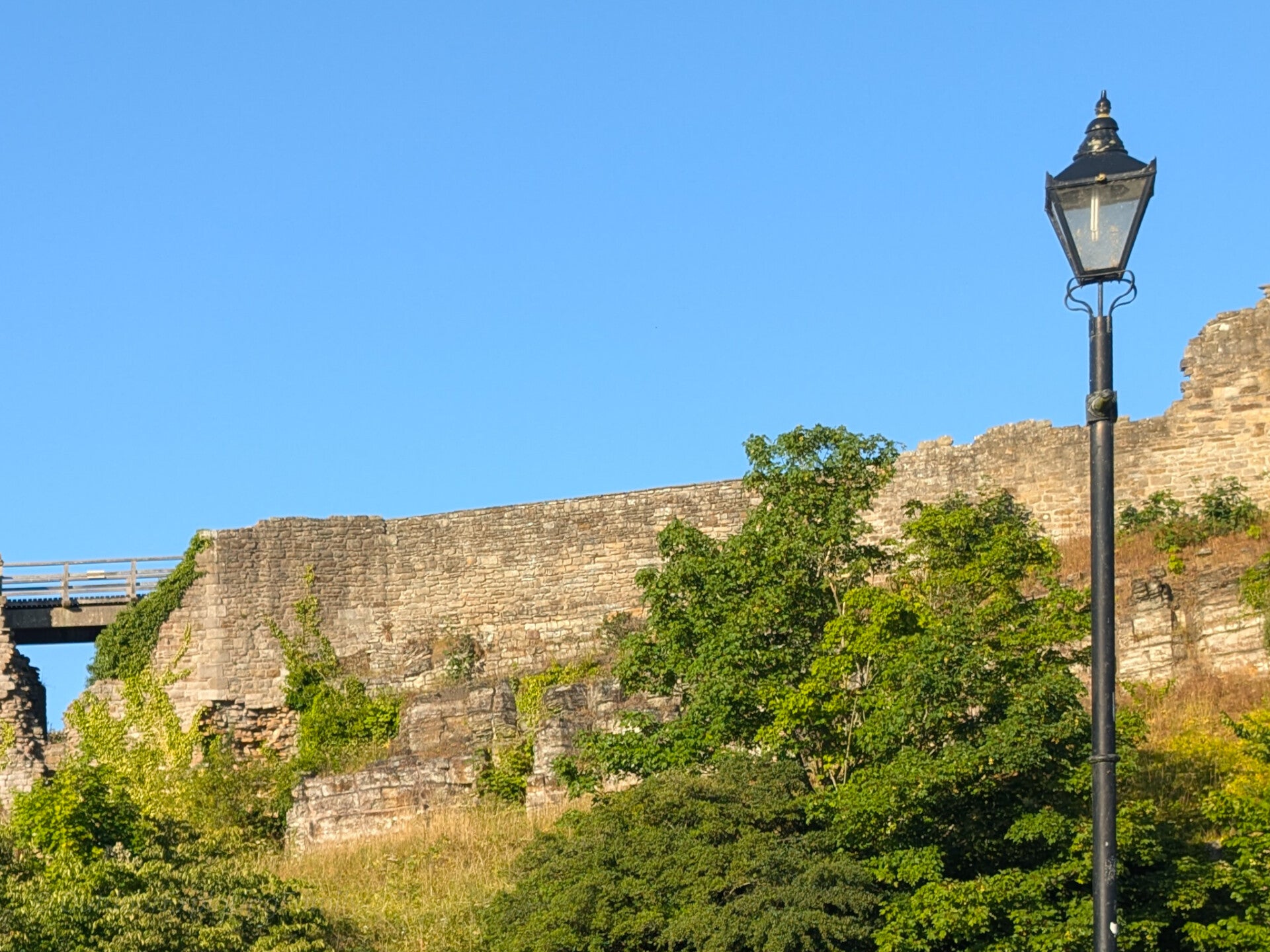 Street lamp standing beside the outer wall of Barnard Castle
