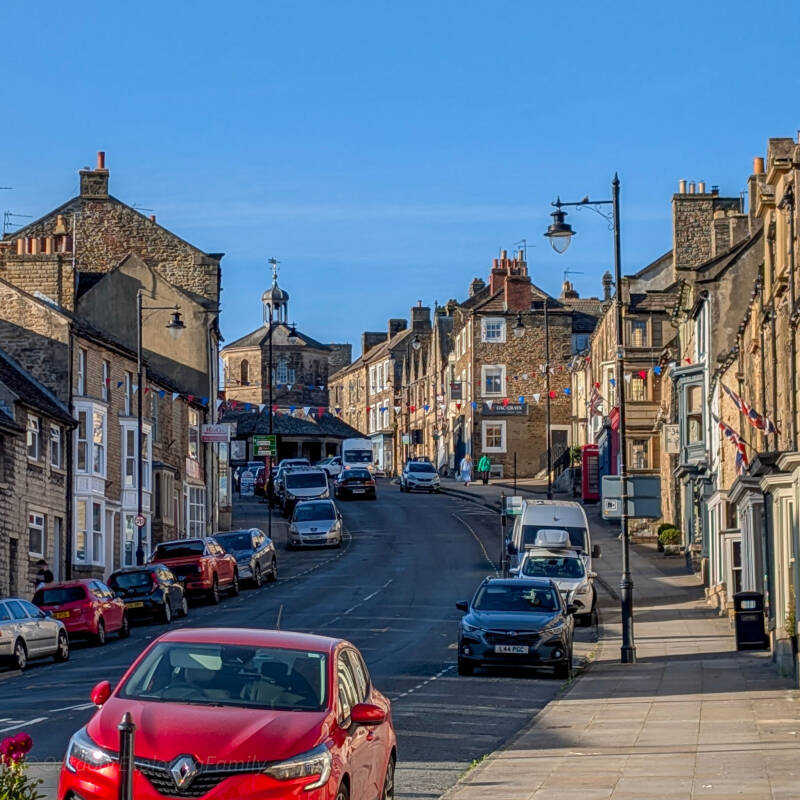 The Bank in Barnard Castle looking uphill towards St Mary’s Church, with historic buildings on both sides.