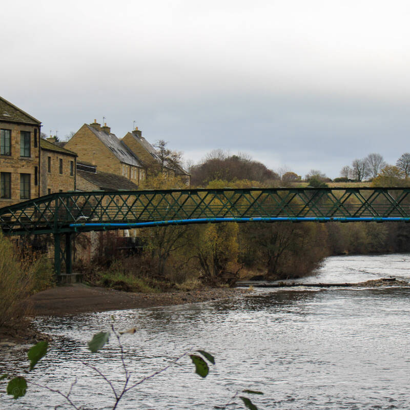 Close view of the green ironwork and lattice structure of Thorngate Bridge over the River Tees at Barnard Castle.