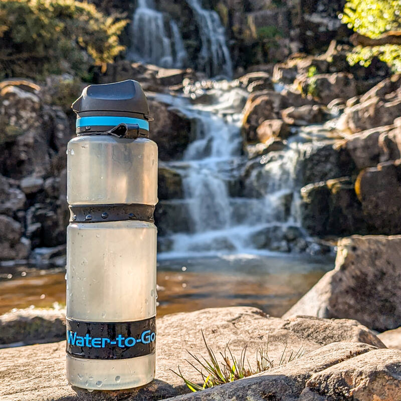 Water to Go bottle collecting water from a waterfall using built in filter