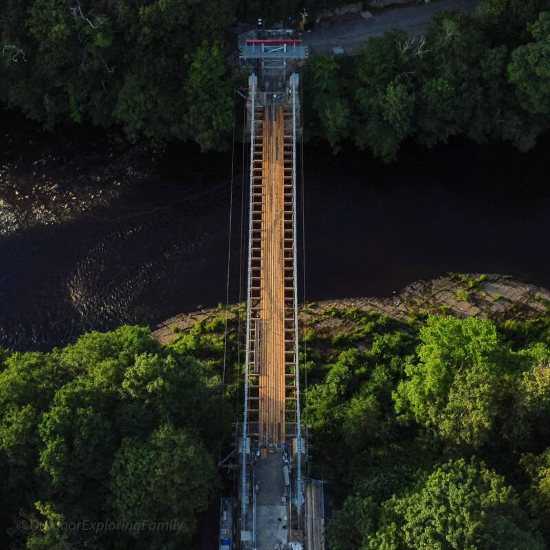 Aerial view of Whorlton Suspension Bridge showing the restored deck and river below
