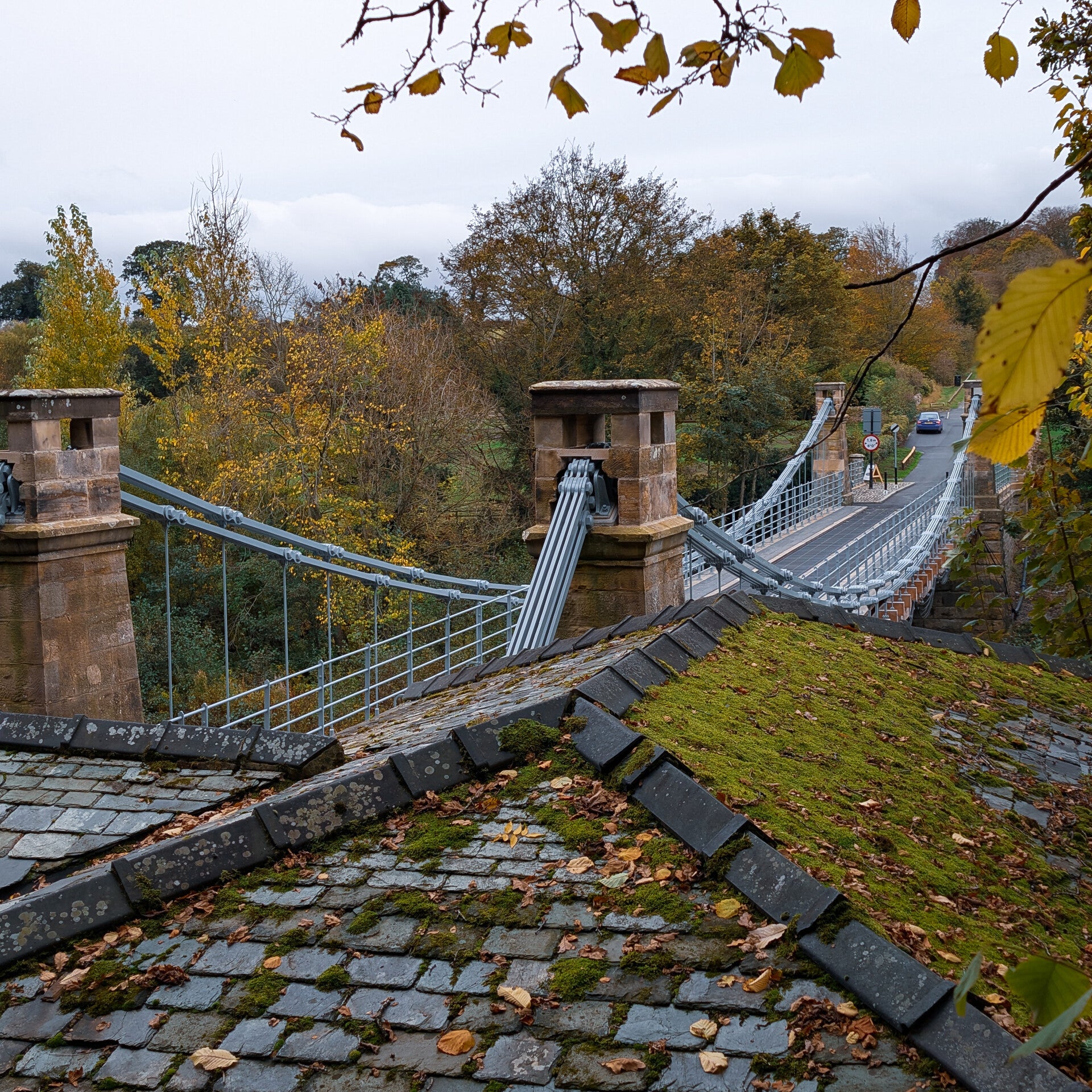 The restored Whorlton Suspension Bridge with its original stone towers and suspension chains spanning the River Tees.