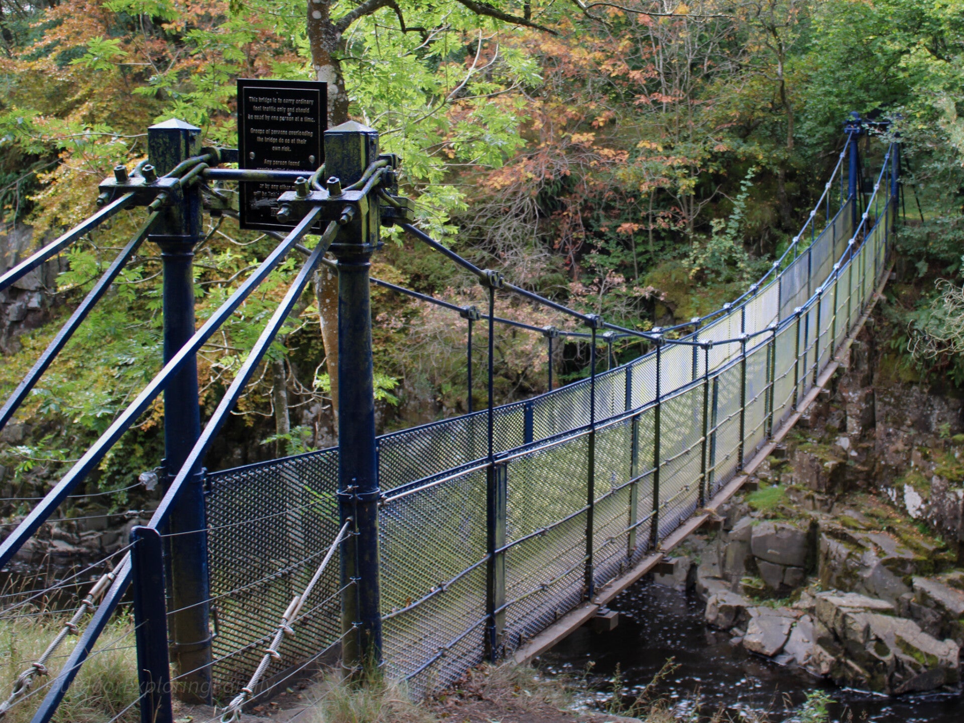 Wynch Bridge suspension footbridge over the River Tees near Low Force in Teesdale surrounded by woodland