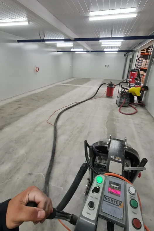 concrete grind in factory, preparing it for epoxy resin coating