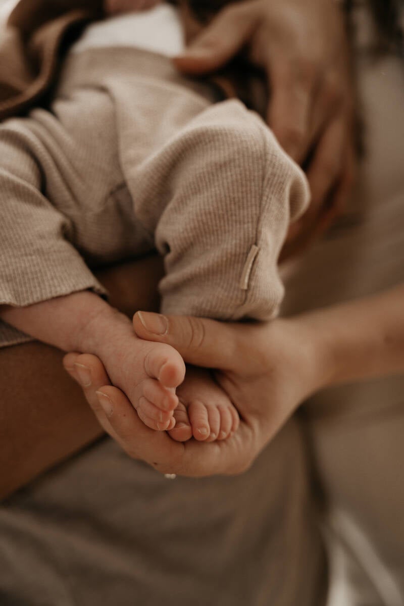 Newbornshoot voetjes handjes slaapkamer bed thuis baby handen details warm