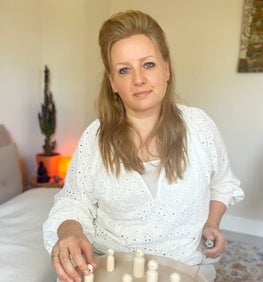 Ervaren vrouwelijke therapeut bij de behandeltafel voor lichaamswerk en massage ter ontspanning en om in contact te komen met je lichaam