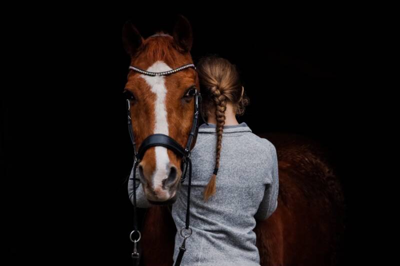 A blacklight picture showing the bond between a rider and her horse