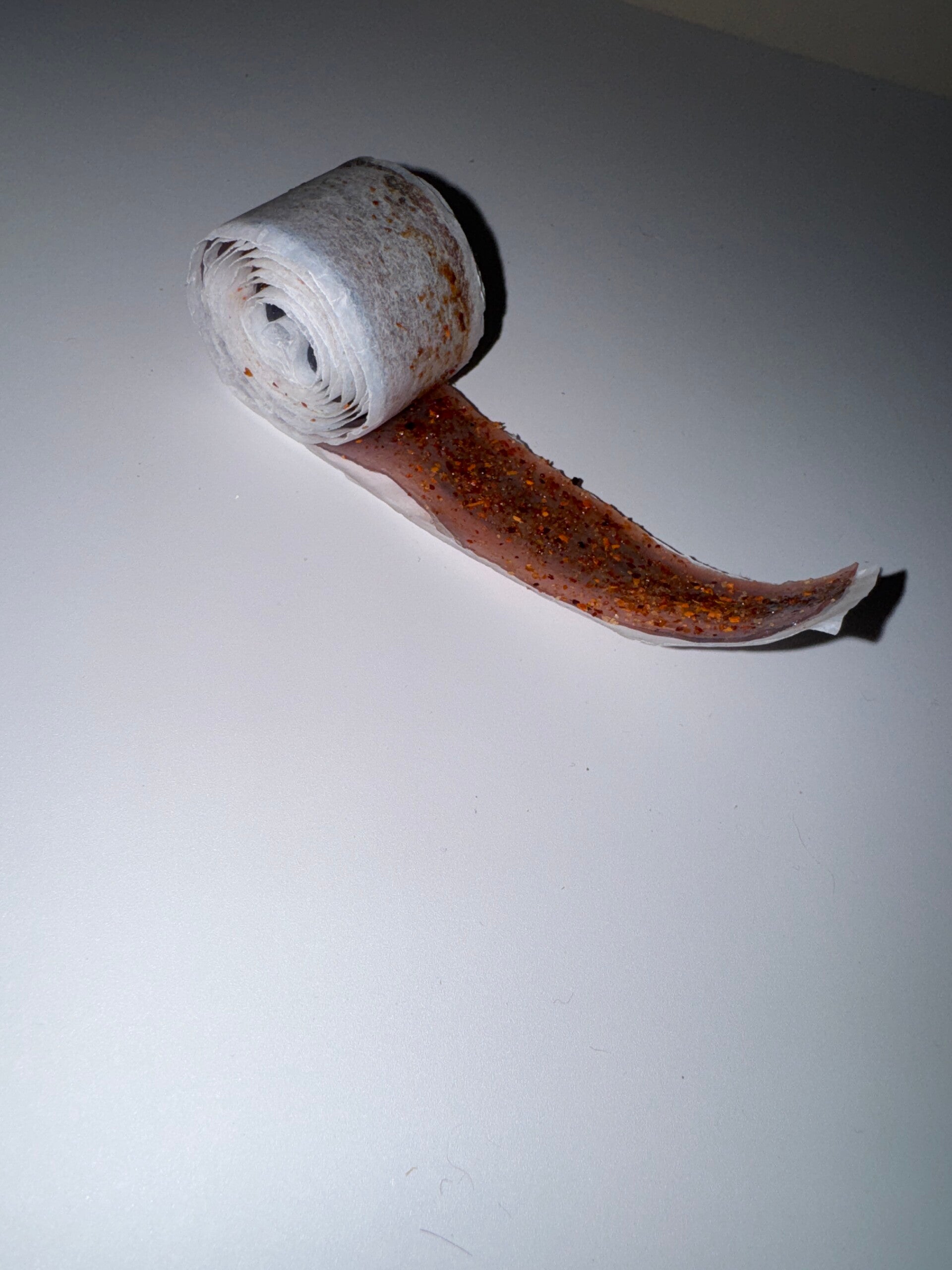 Fruit roll up coated in chamoy and dipped in your choice of powder