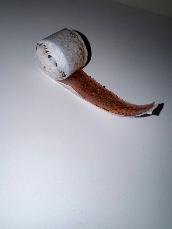 Fruit roll up coated in chamoy and dipped in your choice of powder