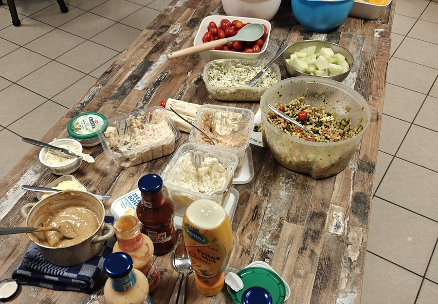 BBQ-tafel met salades, sauzen en bijgerechten bij Let's Meet Wijchen