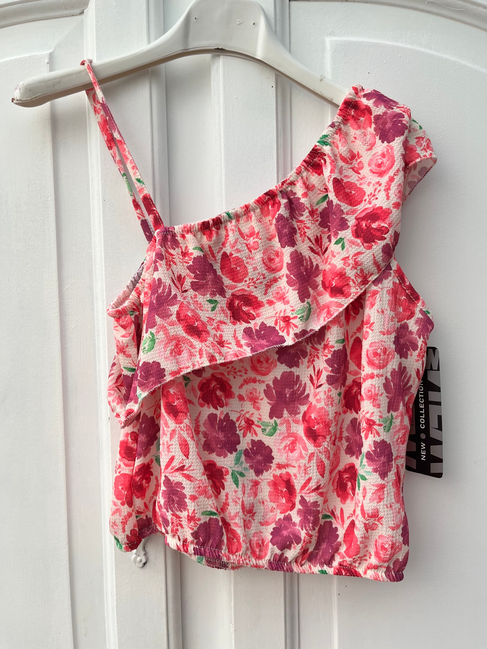 Vrolijk bloementopje van New Collection 🌸 maat 146/152