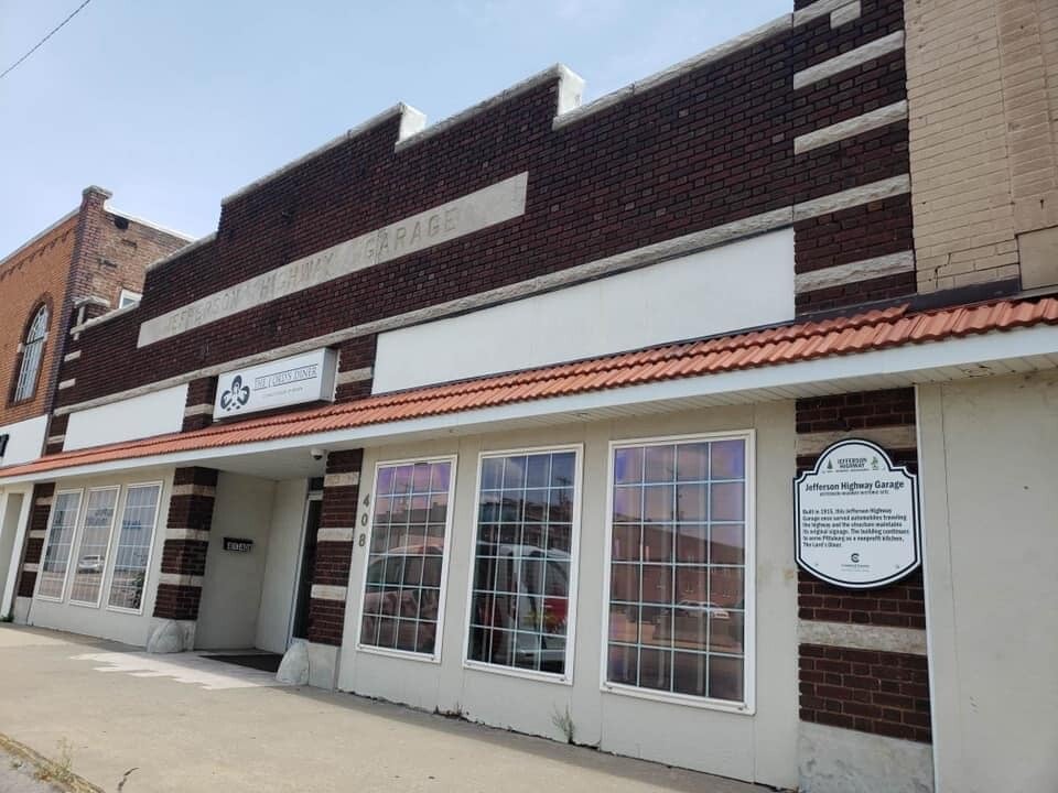 Front exterior of the historic Jefferson Highway Garage in Crawford County in Southeast Kansas. It has a Jefferson Highway marker.