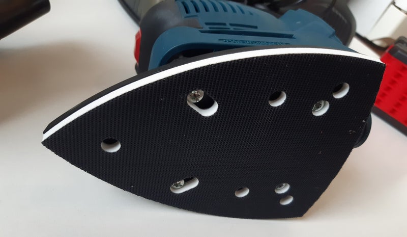 De driehoekige schuurzool van een deltaschuurmachine