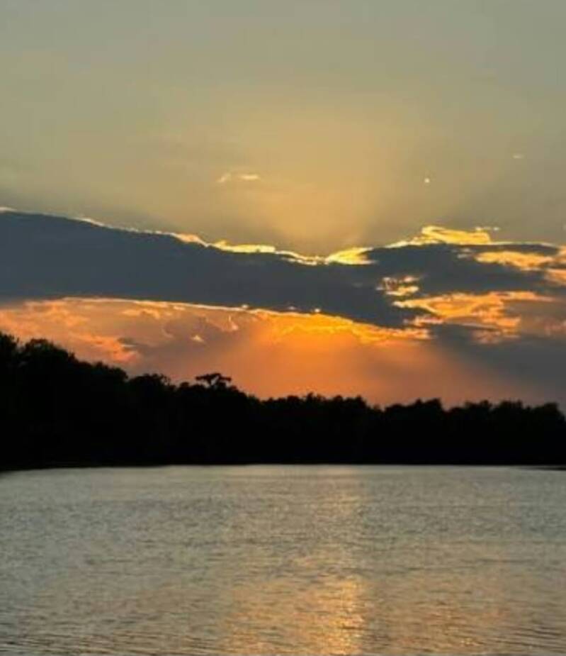 Sunset over Lake Maurepas with orange sky reflecting on the water