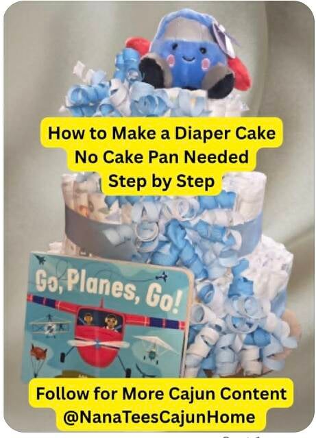 Three-tier airplane themed diaper cake with white and blue curly ribbon, light blue satin ribbons, plush blue airplane topper, and Go Planes Go board book, handmade baby shower gift for army air traffic controller dad from NanaTee's Cajun Home