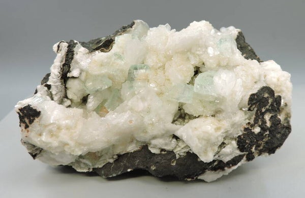 Green apophyllite with prehnite and stilbite on matrix from India – cabinet size