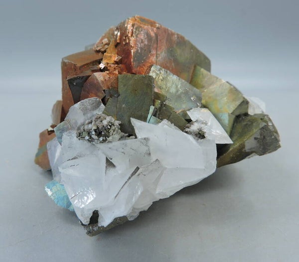 Pink fluorescent calcite on pyrite from Kosovo – small cabinet size