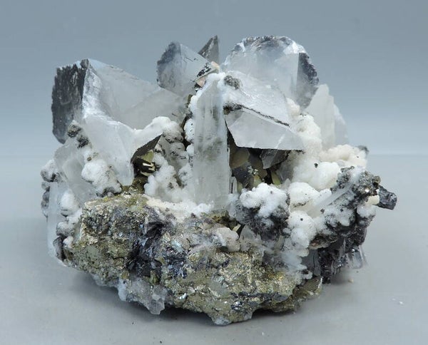 Siderite, sphalerite and pyrite on pink fluorescent calcite from Kosovo – small cabinet size