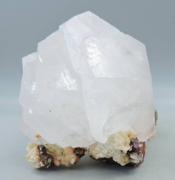 Orange fluorescent calcite with pyrite and rhodochrosite from Kosovo – miniature