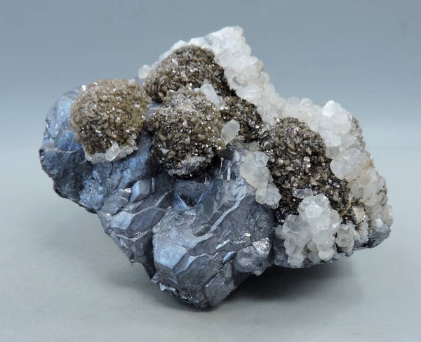 Siderite and pink fluorescent calcite on galena from Kosovo – miniature