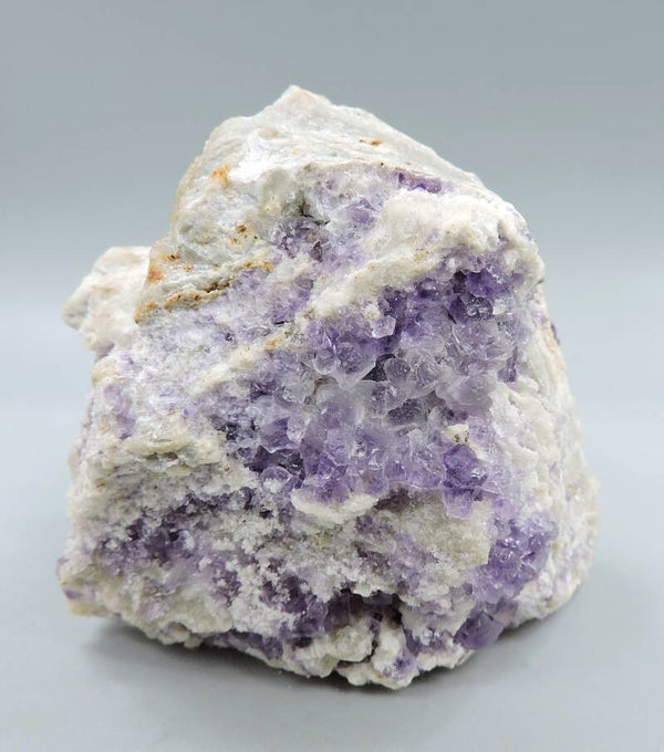 Purple fluorescent fluorite on matrix from Italy – miniature