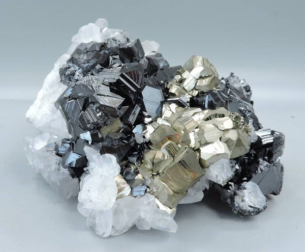 Pyrite and pink fluorescent calcite on sphalerite from Kosovo – small cabinet size