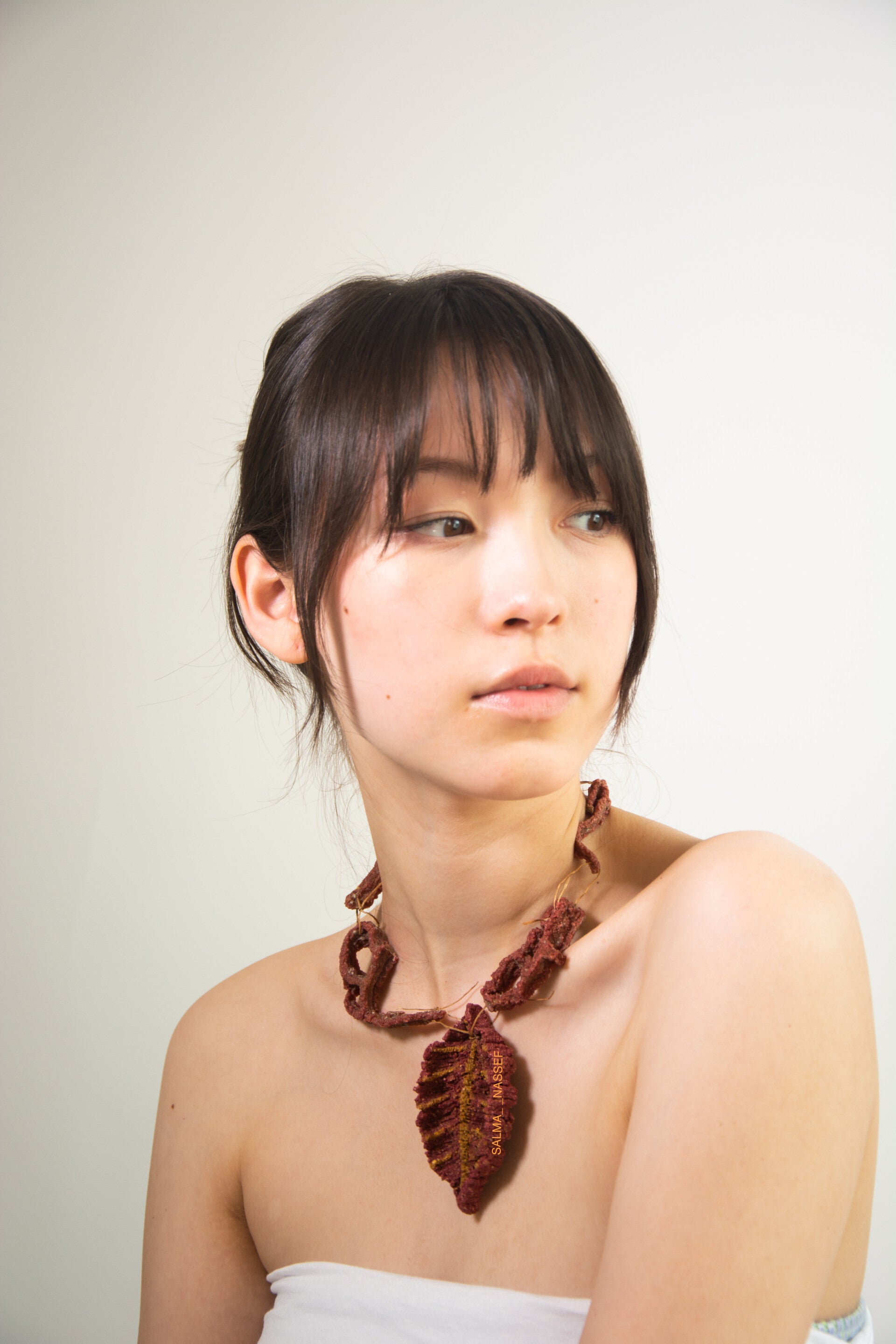 Pink eco-friendly necklace inspired by nature worn by model