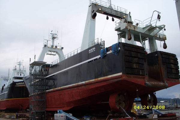 Two, nearly identical ships in dry dock