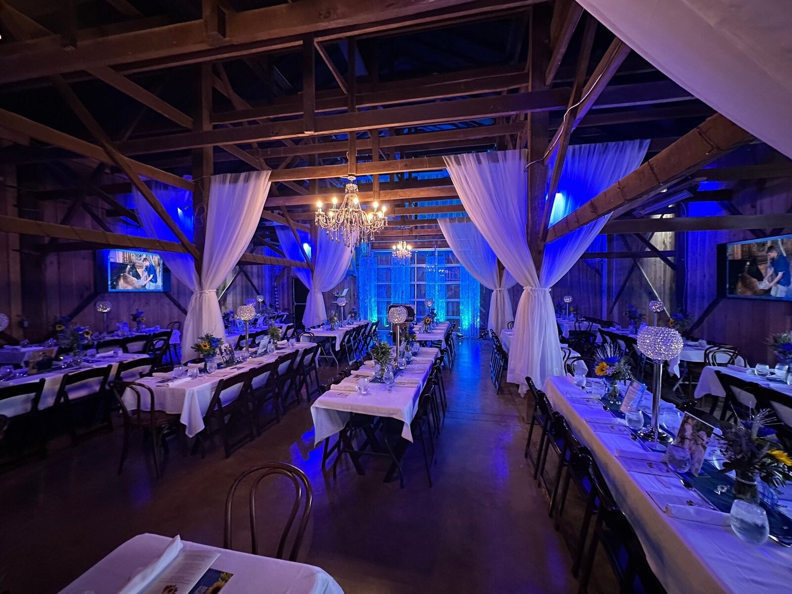 Wedding reception dinner setup in the barn at Farmer & Frenchman