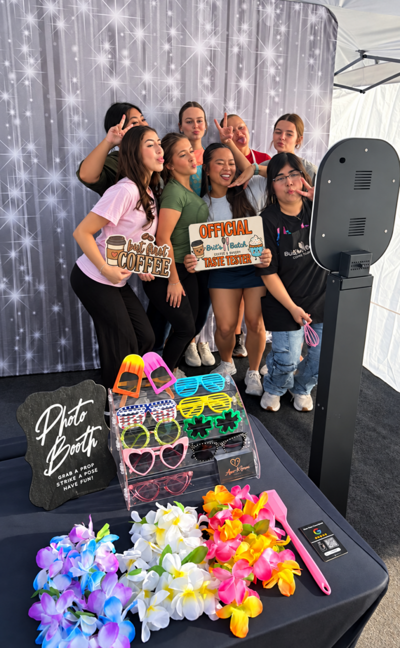 Guests enjoying the Agape and Grace Events photo booth with custom props and a sparkle backdrop at Brit’s Batch.