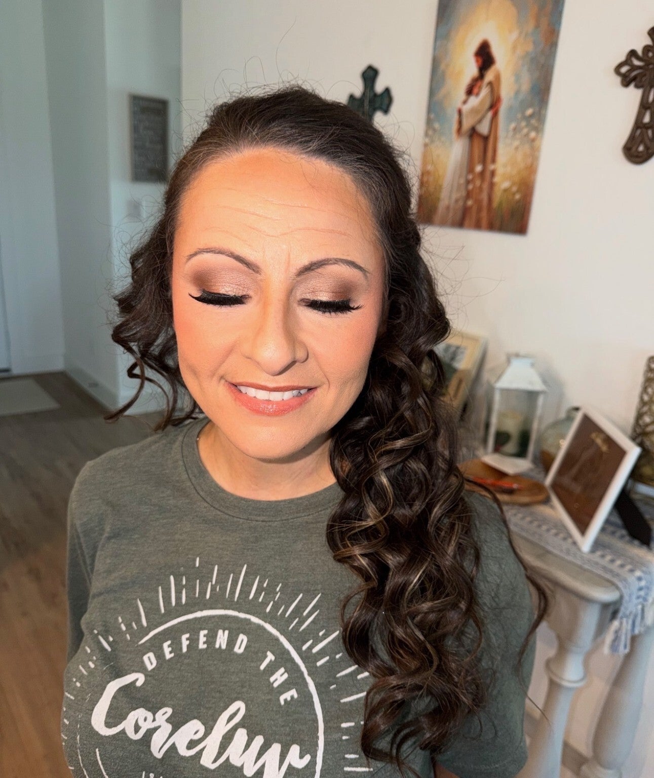 Eyes-closed view of soft glam makeup by Ashley Quick, showing blended bronze shimmer and long lashes.
