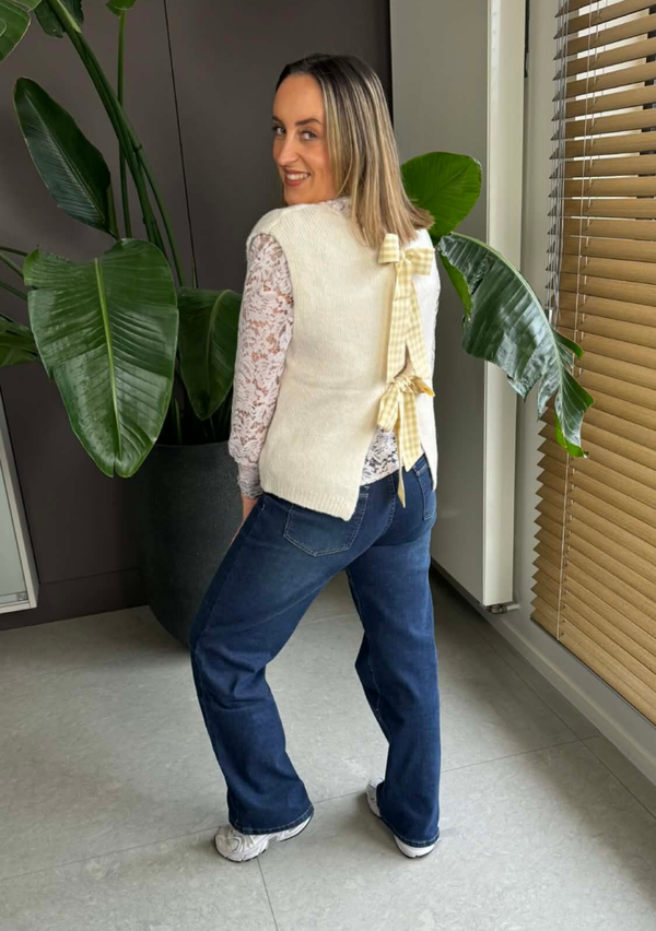 Beige sleeveless bow sweater