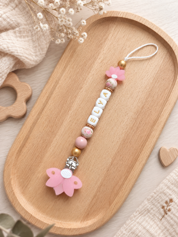Attache tétine fleur de lotus rose pailleté